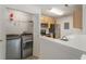 Kitchen with stainless steel appliances, wooden cabinets, and a laundry area at 2011 N Highway 17 # 1400P, Mount Pleasant, SC 29466