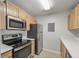 Kitchen features stainless steel appliances, wood cabinets, and light countertops at 2011 N Highway 17 # 1400P, Mount Pleasant, SC 29466