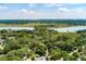 Expansive aerial view showcasing the home's serene setting amidst lush greenery and waterfront surroundings at 2021 Lakeshore Dr, Charleston, SC 29412