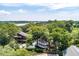 Aerial view of a charming home with lush greenery and distant water at 2021 Lakeshore Dr, Charleston, SC 29412