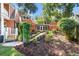 Spacious backyard with an orange house, lush landscaping, gravel, and privacy at 2021 Lakeshore Dr, Charleston, SC 29412