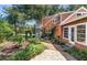 Exterior of the house with lush landscaping, a gravel path, and a well-maintained yard at 2021 Lakeshore Dr, Charleston, SC 29412