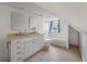 Bright bathroom featuring a double vanity, tan counters, tile flooring, and a bathtub with a shower at 2021 Lakeshore Dr, Charleston, SC 29412