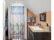 Compact bathroom featuring beach-themed decor, a single sink vanity, and a shower at 2021 Lakeshore Dr, Charleston, SC 29412