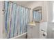 Cozy bathroom with tiled bathtub, shower curtain, and classic vanity at 2021 Lakeshore Dr, Charleston, SC 29412