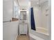 Clean, well-lit bathroom with white tile, a modern vanity, and a tub with shower at 2021 Lakeshore Dr, Charleston, SC 29412