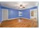 Bedroom with hardwood floors, a ceiling fan, and blue painted walls at 2021 Lakeshore Dr, Charleston, SC 29412
