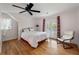 Bedroom featuring hardwood floors, ceiling fan, and french doors to a balcony at 2021 Lakeshore Dr, Charleston, SC 29412