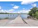 Picturesque boat ramp leading into calm waters under a bright, partly cloudy sky at 2021 Lakeshore Dr, Charleston, SC 29412