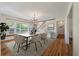 Dining room featuring hardwood floors, modern table and chairs, and bright light fixtures at 2021 Lakeshore Dr, Charleston, SC 29412