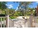 Scenic view of the gravel driveway and lush greenery, creating a tranquil approach to the property at 2021 Lakeshore Dr, Charleston, SC 29412