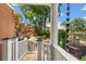 Beautiful front porch features a white pillar, wood floors, and an inviting view of lush landscaping at 2021 Lakeshore Dr, Charleston, SC 29412