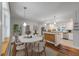 Bright kitchen with white cabinets, stainless steel appliances, and a dining area with chairs at 2021 Lakeshore Dr, Charleston, SC 29412