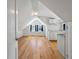 Bright kitchenette featuring white cabinets, light countertops, wood floors, and natural light from windows at 2021 Lakeshore Dr, Charleston, SC 29412