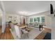 Bright living room with hardwood floors, a bay window, and stylish decor, creating a cozy atmosphere at 2021 Lakeshore Dr, Charleston, SC 29412