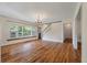 Living room featuring hardwood floors, staircase with white railing, and large picture window at 2021 Lakeshore Dr, Charleston, SC 29412