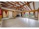 Spacious sunroom with exposed beams, a stone fireplace, and plenty of natural light for comfortable living at 2021 Lakeshore Dr, Charleston, SC 29412