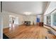 Bright living room featuring wood floors, chandelier, and views into other rooms at 2021 Lakeshore Dr, Charleston, SC 29412