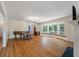 Spacious living room featuring hardwood floors, large bay window, fireplace, and piano at 2021 Lakeshore Dr, Charleston, SC 29412