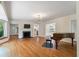 Open living room with fireplace, hardwood floors, and piano at 2021 Lakeshore Dr, Charleston, SC 29412