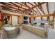 Bright and airy sunroom with exposed beams, a stone fireplace, and tile floors, ideal for relaxation at 2021 Lakeshore Dr, Charleston, SC 29412