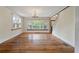 Spacious living area with hardwood floors, chandelier, and large windows offering plenty of natural light at 2021 Lakeshore Dr, Charleston, SC 29412