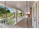 Inviting porch with a swing, chairs, and views of the landscaped garden at 2021 Lakeshore Dr, Charleston, SC 29412