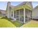 Backyard showcasing a screened-in porch and well-maintained lawn at 232 Moon Dance Ln, Summerville, SC 29483