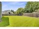Well-maintained, grassy backyard enclosed by a wooden fence, with neighboring homes visible at 232 Moon Dance Ln, Summerville, SC 29483