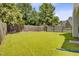 Expansive backyard featuring a manicured lawn and a wooden privacy fence at 232 Moon Dance Ln, Summerville, SC 29483