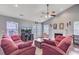 Cozy living room featuring a fireplace, ceiling fan, TV, and comfortable seating at 232 Moon Dance Ln, Summerville, SC 29483