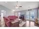 Bright living room with a ceiling fan, TV, patio doors and comfortable sofa at 232 Moon Dance Ln, Summerville, SC 29483