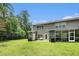 Lush green backyard showcasing a well-maintained lawn, patio, and screened in porch for outdoor relaxation at 234 S Lamplighter Ln, Summerville, SC 29486
