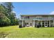Spacious backyard offers outdoor living and entertaining with a lush green lawn, and screened in porch at 234 S Lamplighter Ln, Summerville, SC 29486