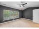 Spacious bedroom featuring plush carpet, a ceiling fan, and a bright window view at 234 S Lamplighter Ln, Summerville, SC 29486
