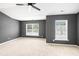 Empty bedroom with carpet, ceiling fan, gray walls, and two windows at 234 S Lamplighter Ln, Summerville, SC 29486
