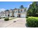 Beautiful townhomes with neat landscaping, individual garages, and inviting curb appeal at 234 S Lamplighter Ln, Summerville, SC 29486