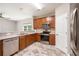 Well-lit kitchen featuring stainless steel appliances, wood cabinets, and durable countertops at 234 S Lamplighter Ln, Summerville, SC 29486