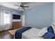 Comfortable bedroom with a large window, wood floors, ceiling fan, and a mounted TV at 2668 Crooked Stick Ln, Mount Pleasant, SC 29466