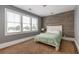 Inviting bedroom with wood accent wall, large windows and neutral carpet at 2668 Crooked Stick Ln, Mount Pleasant, SC 29466