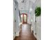 Grand entryway features a beautiful wood door, hardwood floors, and elegant trim details at 2668 Crooked Stick Ln, Mount Pleasant, SC 29466