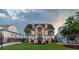 Inviting coastal home featuring a manicured lawn, palm trees and an elevated front entrance at 2668 Crooked Stick Ln, Mount Pleasant, SC 29466