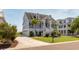 Charming blue two-story home with three-car garage, covered porch, and manicured landscaping at 2668 Crooked Stick Ln, Mount Pleasant, SC 29466