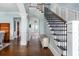 Elegant foyer with hardwood floors, staircase with wrought iron railings and decorative columns at 2668 Crooked Stick Ln, Mount Pleasant, SC 29466