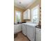 Bright laundry room with granite countertop and tile floors at 2668 Crooked Stick Ln, Mount Pleasant, SC 29466