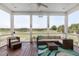 Relaxing screened porch with comfortable seating and scenic views of the golf course at 2668 Crooked Stick Ln, Mount Pleasant, SC 29466