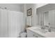 Clean bathroom with a shower, white vanity, and a framed starfish picture at 2722 Sunrose Ln, Johns Island, SC 29455