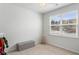 A simple, well-lit bedroom with neutral walls, carpet, and a large window at 2722 Sunrose Ln, Johns Island, SC 29455