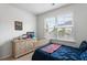 Bright bedroom showcasing a neutral color palette, natural light and a playful touch with comic decor at 2722 Sunrose Ln, Johns Island, SC 29455