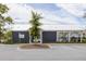Community clubhouse with outdoor pool, parking, landscaping, and 'Woodbury Park' sign at 2722 Sunrose Ln, Johns Island, SC 29455